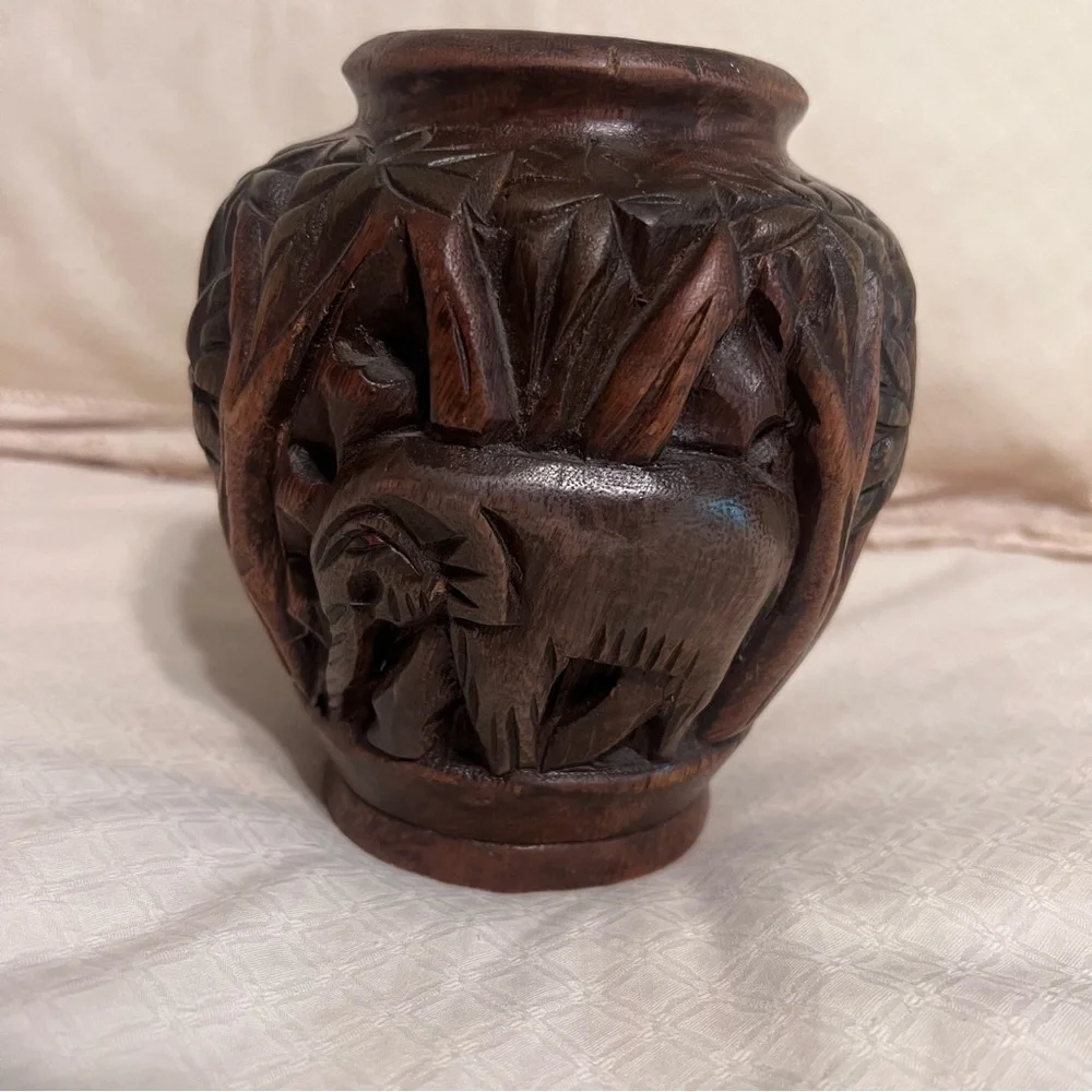 Carved wooden type vase with elephant. Approximately 6 inches high.